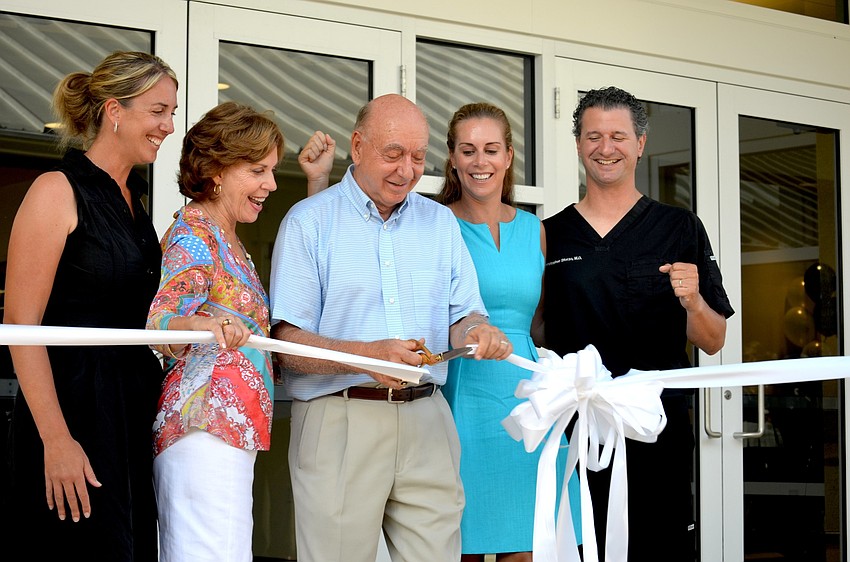 The Vitale family — Sherri, Lorraine, Dick, Terri and her husband, Christopher Sforzo — cut the ribbon on the student center.