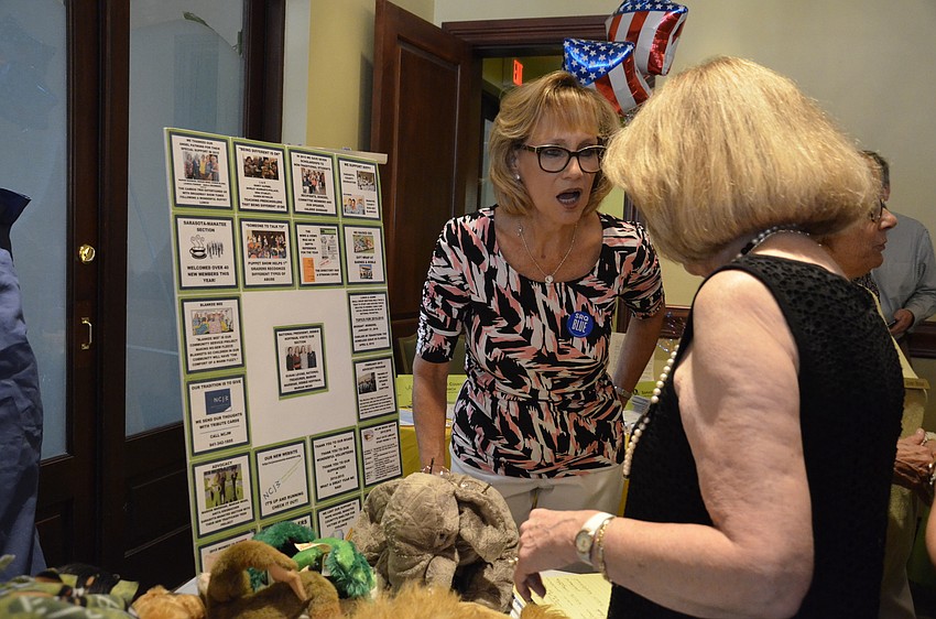 Nina Stanley talks with Marion Marshak at the National Council of Jewish Women booth.