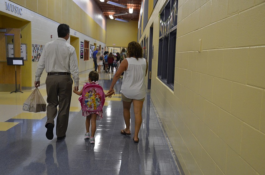 Tony and Angela Campano walk Skyla, 5, to her first day of school.
