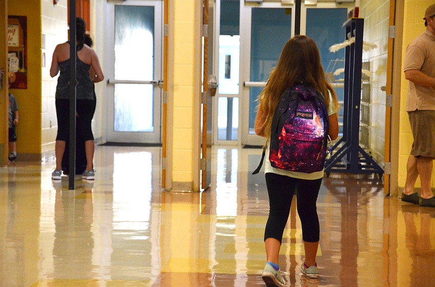 Nicole Mendoza, 10, finds her way to her fifth-grade classroom.