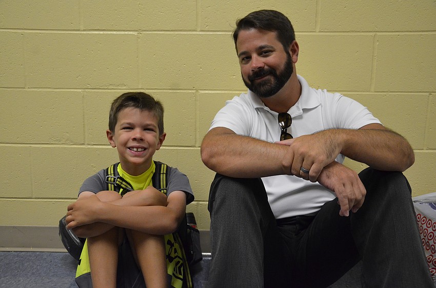 Jared Buckson sits with his son, Isaiah, 7, before school starts.