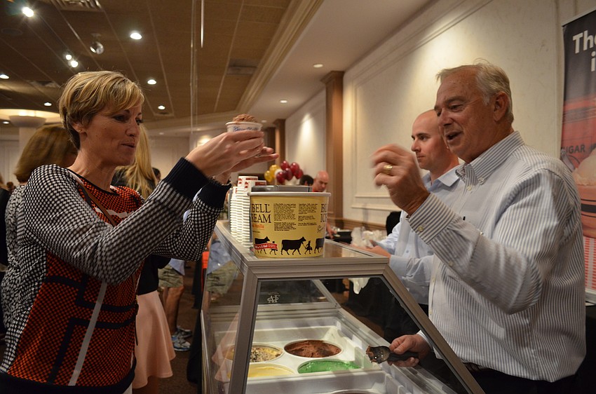 Mike Forse serves a scoop of Blue Bell Dutch chocolate ice cream to Felicia Cox.