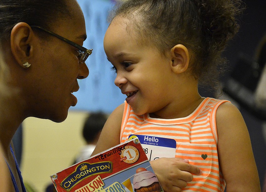 Deja Rivera talks with her daughter, Laila, before she starts her first-ever day of school.