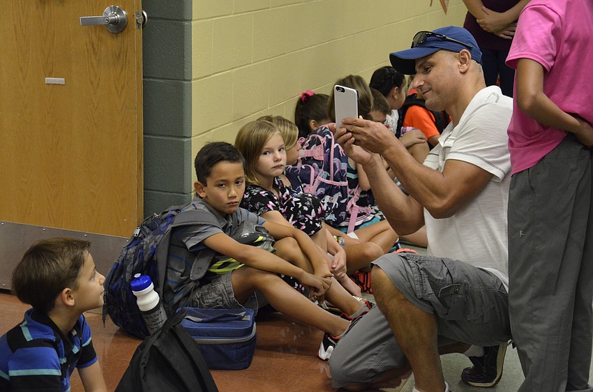 Pllund Suka snaps one last shot of his son, Andre, 7, before he ventures into second grade.