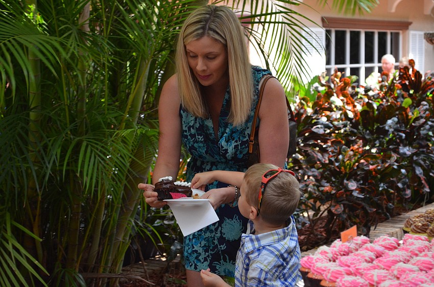 Jonah Quarls picks out cupcakes with his mother Kristi Quarls.