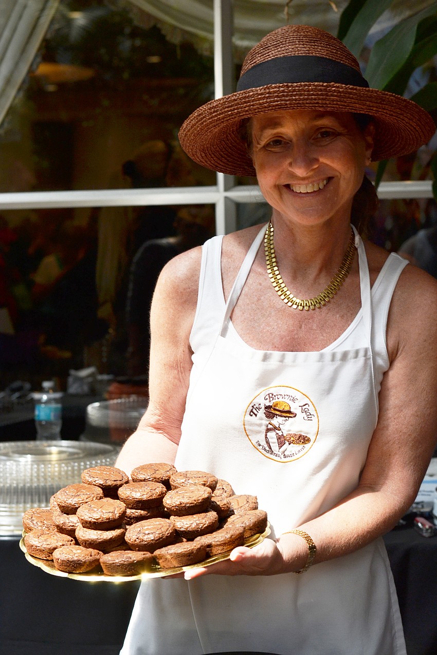 Marla Robbins is The Brownie Lady with a tray of her original brownies.