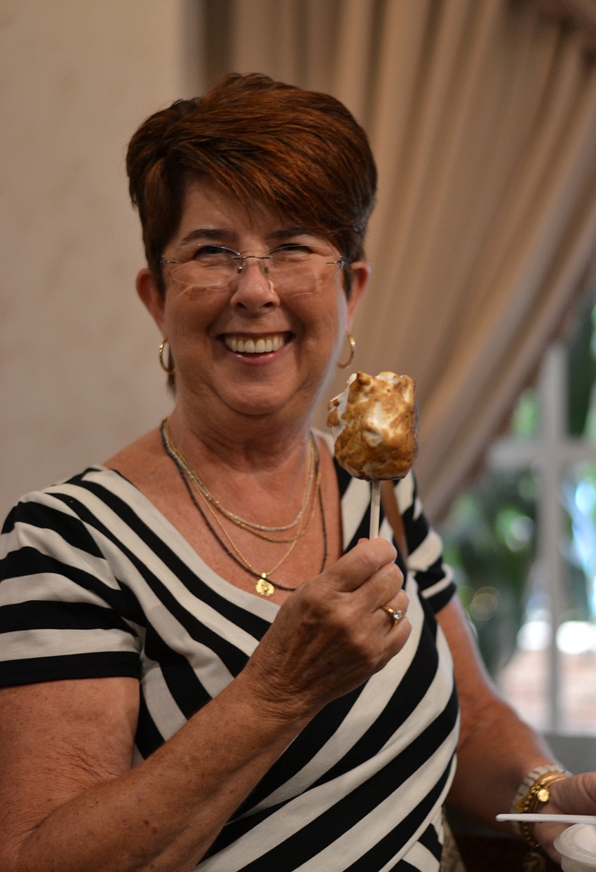 Maureen Baker samples a double-dipped marshamallow from Michael’s on East.