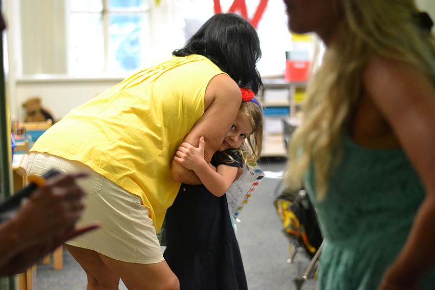 Audrey Reuter hugs her teacher Ileana Manzano.