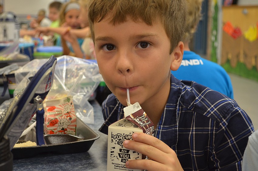 Taylor Johnson sips his chocolate milk.