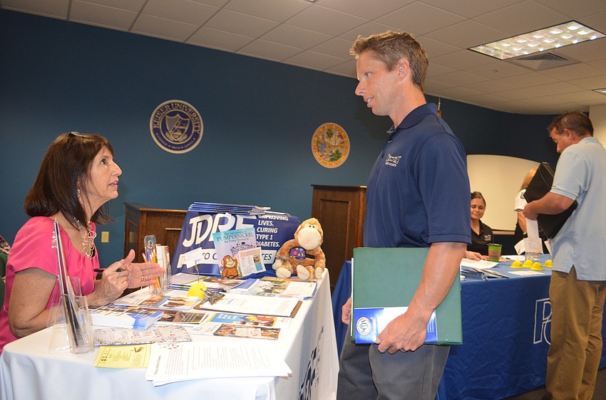 Angela Steusloff and Chris Bear mull over work options at Juvenile Diabetes Research Foundation.