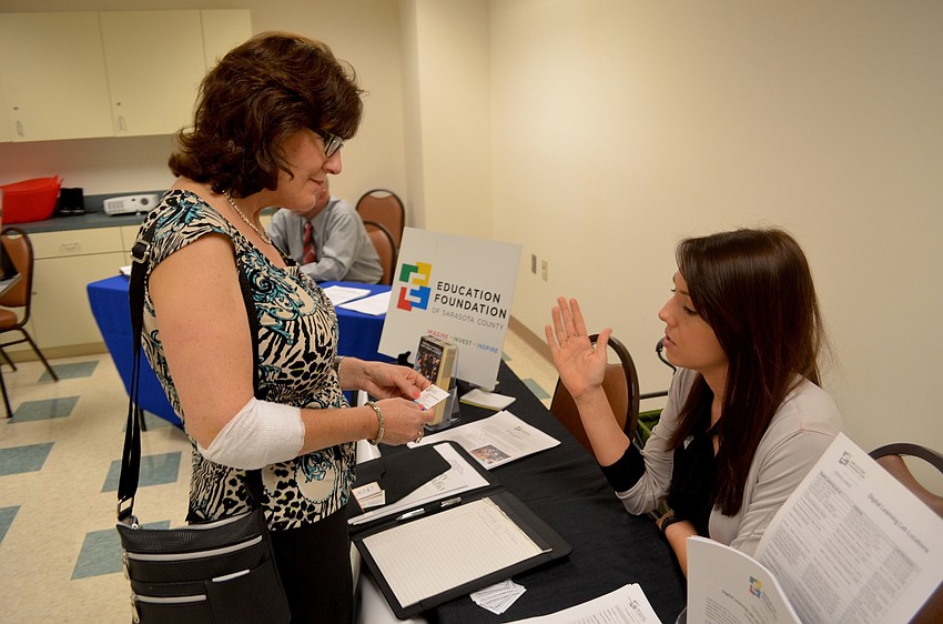 Patti Bonagiano and Jennifer Sams, of the Education Foundation of Sarasota County, review job openings.