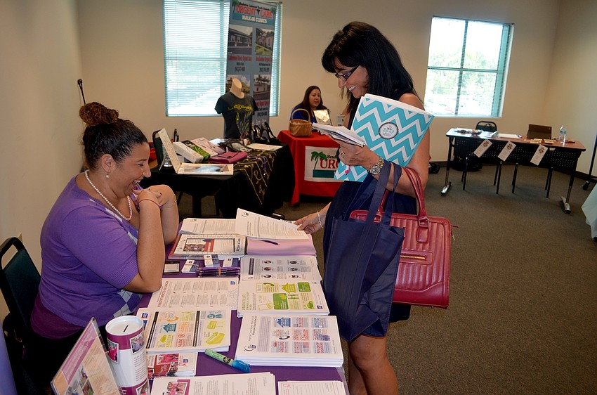 American Cancer Association representative Natalie Chambers describes to Sharon Smyth open positions.