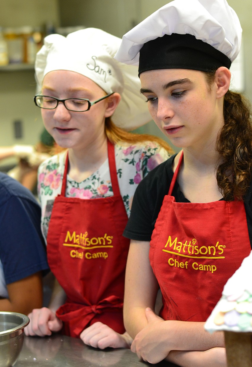 Sam Schanely and Annabel Norman-Webb watch closely for cooking instructions.