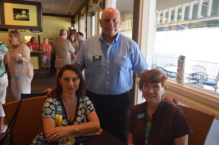 Irina LaRose, of Design 2000, Chamber Ambassador Mike LaPorta and Nancy Taussig, of Barefoot Weddings
