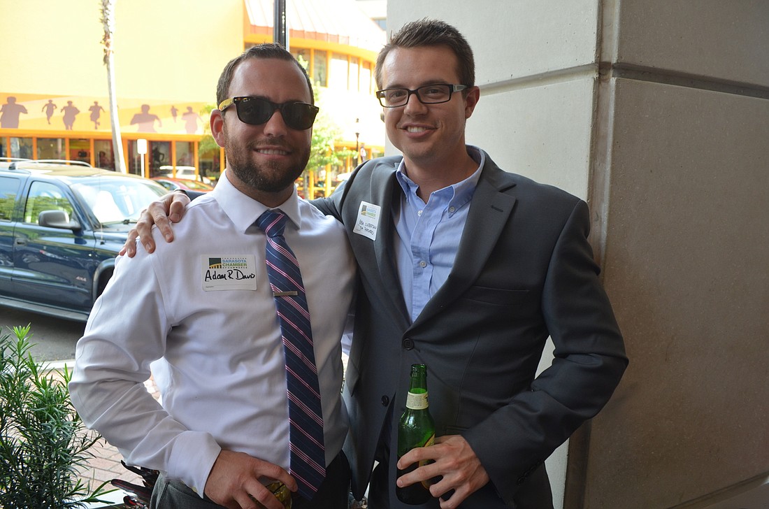 File photo. Adam Davis and Ben Culbertson enjoy a monthly YPG After Hours networking event.