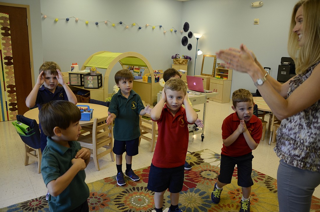 Marlene Shellhammer and her students practice the listening and following instructions song.
