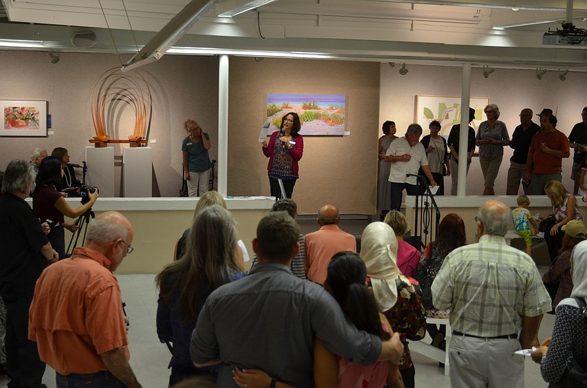 Lisa Berger, executive director, announces the honorable mentions and winners of the open exhibit competition.
