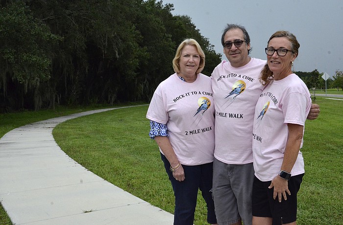 Margo Diener, left, organized the walk with help from Peter and Sandy Gatti, right, residents of Riverview, north of the Manatee River.