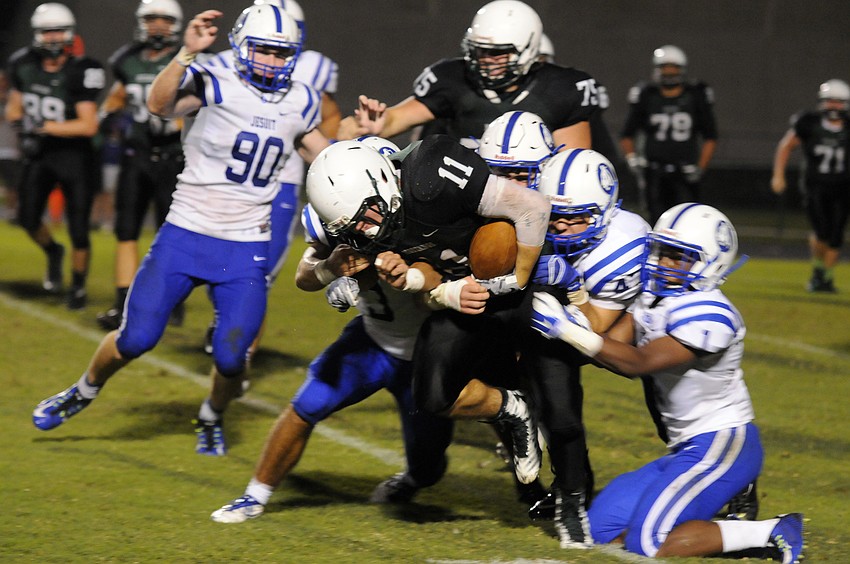 Running back Justin Fischer fights for yardage in the second half. Fischer scored the Mustangs lone touchdown in the first half on a 4 yard carry.