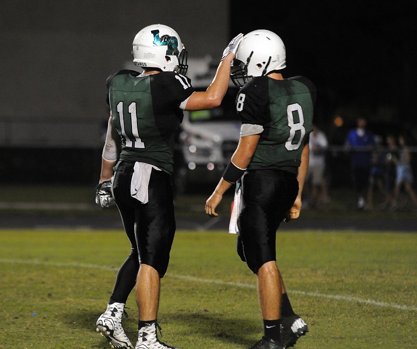 Running back Justin Fischer reminds quarterback Justin Curtis to keep his head up in the first half.