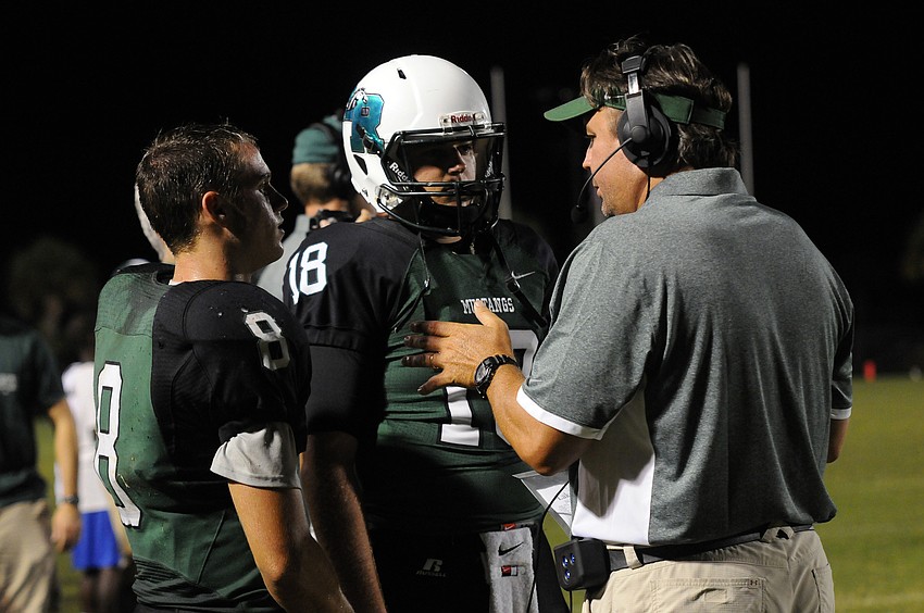Lakewood Ranch coach Mick Koczersut gives some advice to quarterbacks Justin Curtis and Grant Weisman.