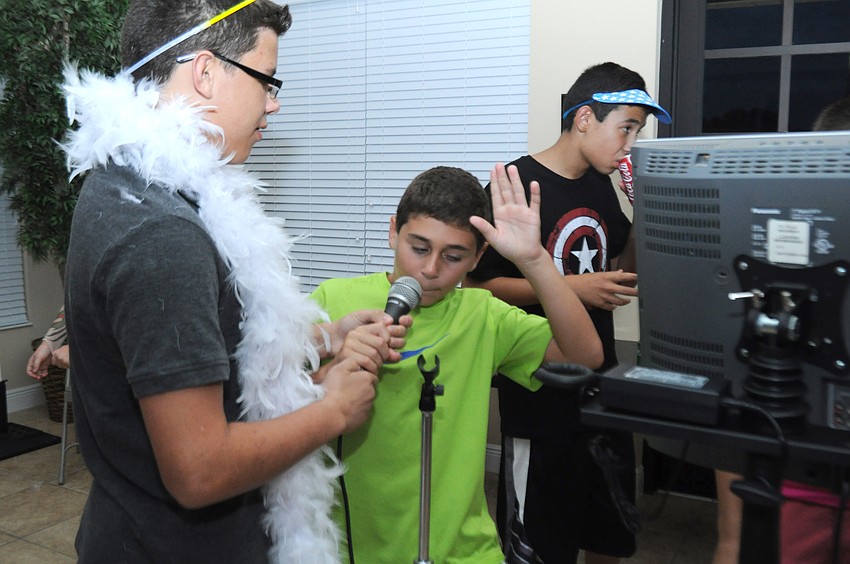Anthony Salerno, 13, and Drew Marra, 11, belt out a karaoke song.