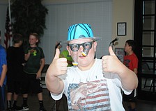 Gary Whetsell, 11, rocks a pair of googly eyes from the photo booth.