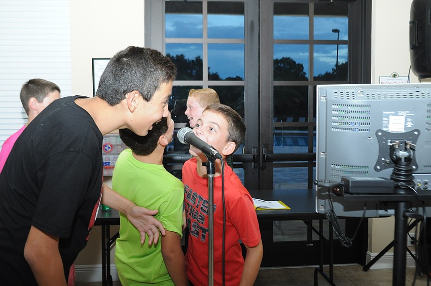 Jace Chapman, 12, and Matthew Perri, 11, sing karaoke.