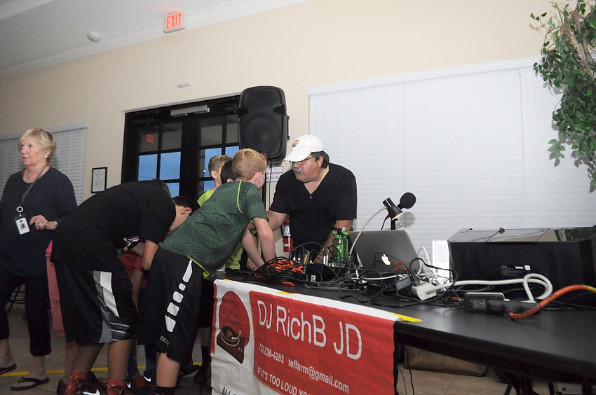 Richard Biribauer, the DJ, talks with some karaoke-minded boys.