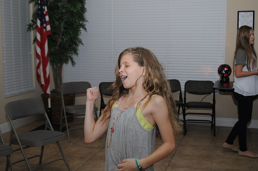 Sophia Lanni, 11, rocks out to her song.