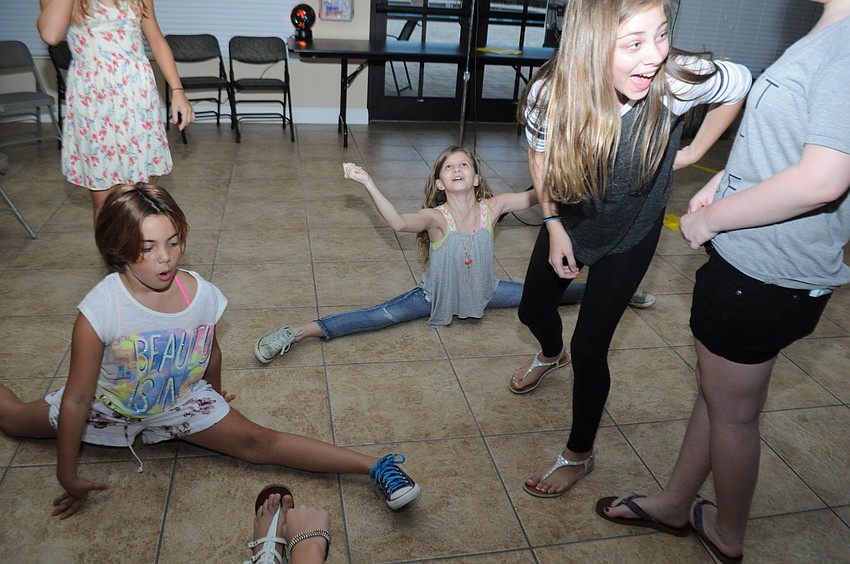 Zoe Apotsos and Sophia Lanni, 11, do the splits to the amazement of Jade Merriman, 11.