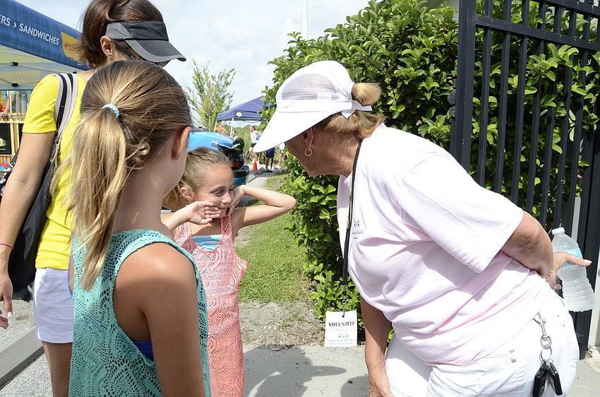 Charlotte Griffin and daughters Alexandra, 9, and Maya, 7, talk with Carlene Smith, vice president of Lakewood Ranch Community Activities.