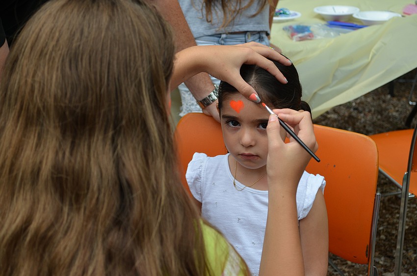 Ariana Ackerman has her face painted.