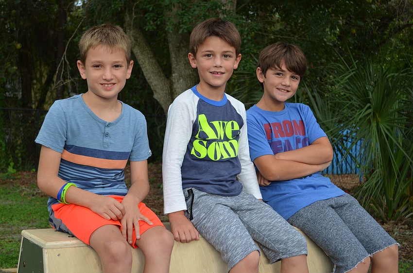 Hayden Stroude, River and Rocco Rell sit atop of the volt for the parkour course.