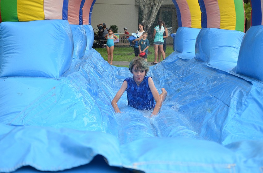 Jackson Cutler slips down the water slide.