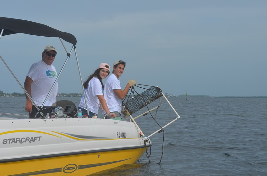 Steve, Ellie and Jack Martin check on a scallop sanctuary.