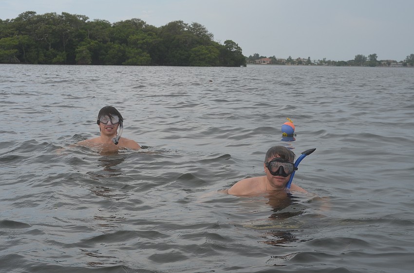 John Okovach and Jeff Schaefer search for scallops.