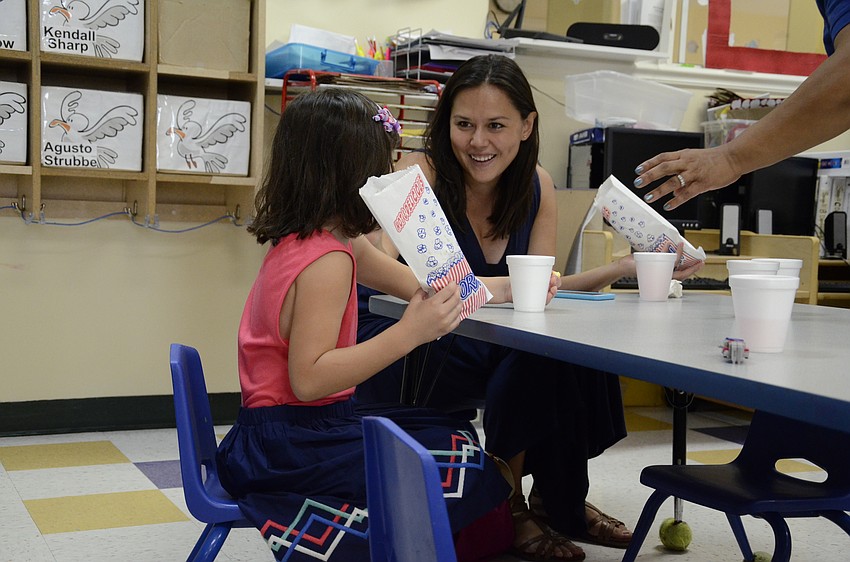 Carolina Sanchez and her daughter, Camila, 4, chat over a banana snack.