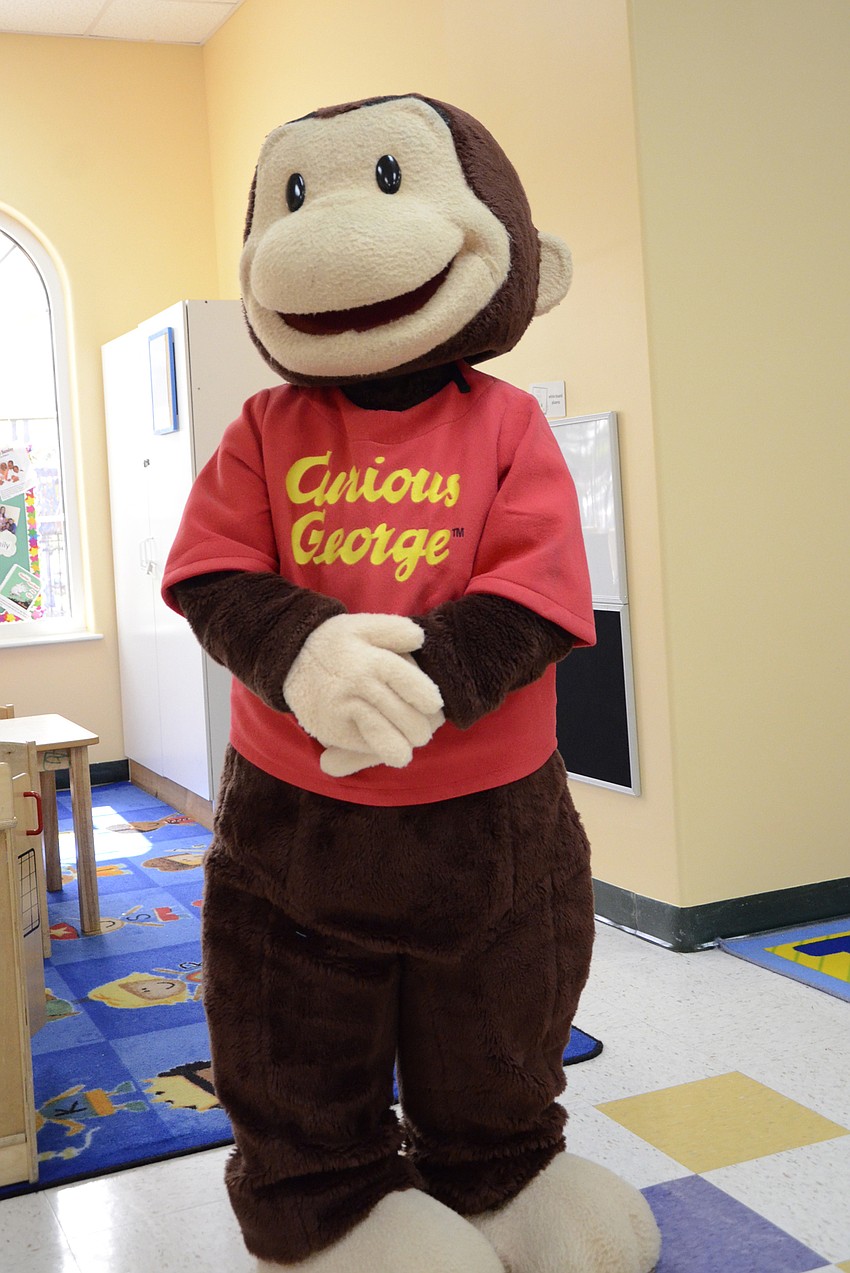 Curious George (played by Academy teacher Morgan Murray) visited with children and took photos.