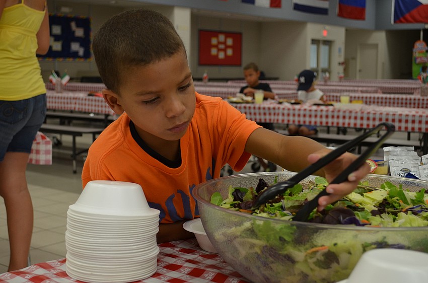 Casey Izquierdo loads up on salad.
