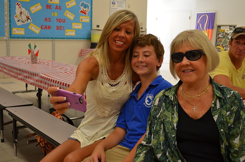 Rae Tomaseski, Geno Guiliani and JoAnn Tomaseski squeeze together for a selfie.