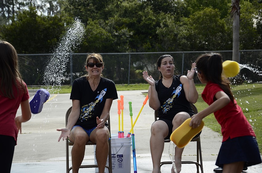 Principal Hayley Rio and Assistant Principal Samantha Webb prepare to get soaked.