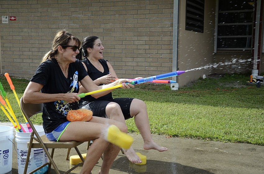 Principal Hayley Rio and Assistant Principal Samantha Webb didn't come to the sponge toss unarmed—they brought some water shooters to squirt at the students.