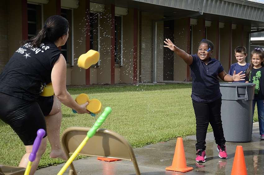 Assistant Principal Samantha Webb catches a sponge thrown by Cynai Young.