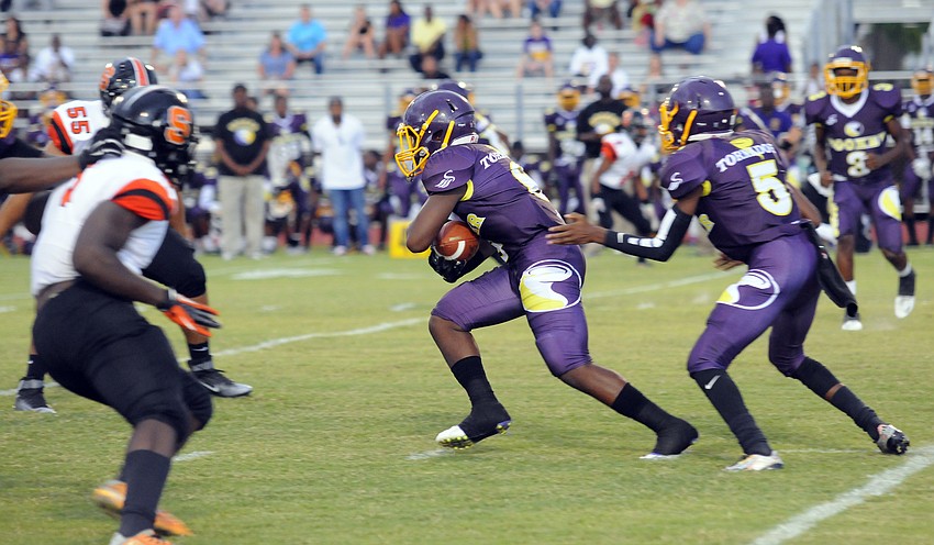 Booker running back Jamal Benson carries the ball for a positive gain.