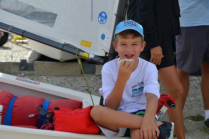 Callen Burnett takes a break to eat his lunch.