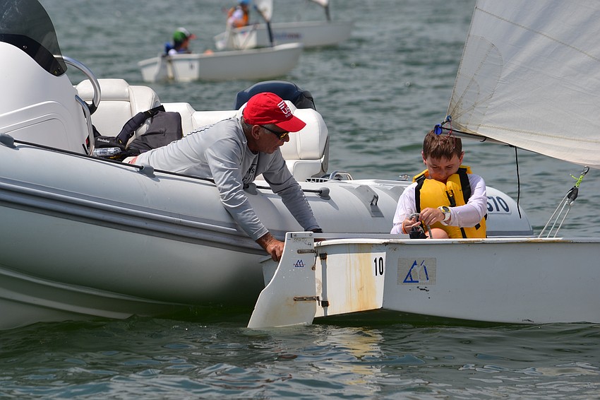 Michael Childers has some repairs on his boat just before the race starts.