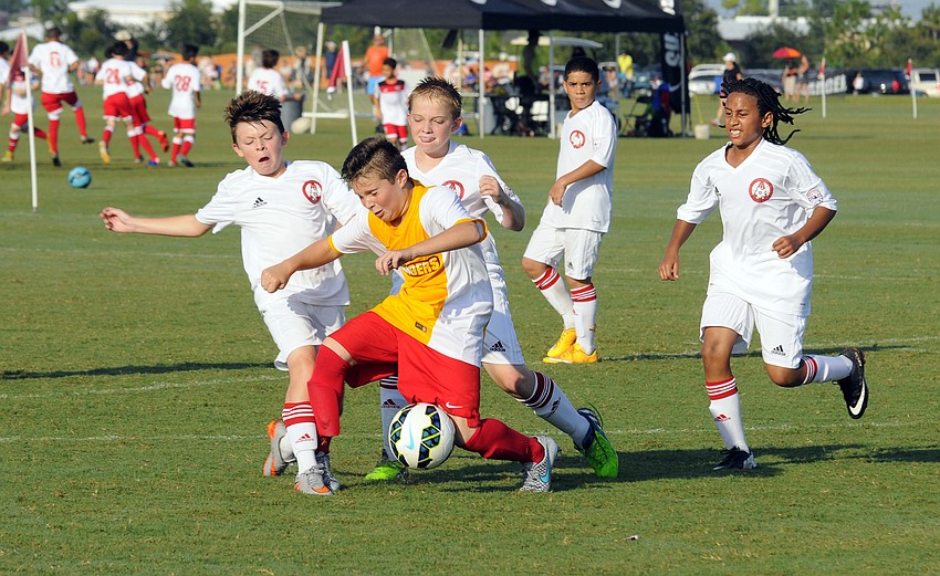 Lakewood Ranch Chargers midfielder Jason Biro attempts to maintain possession.