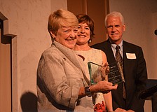Carolyn Johnson accepts the 2015 Boundary Crosser award from Cathy Layton and Dan Bailey.