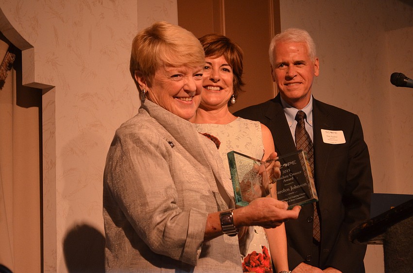 Carolyn Johnson accepts the 2015 Boundary Crosser award from Cathy Layton and Dan Bailey.